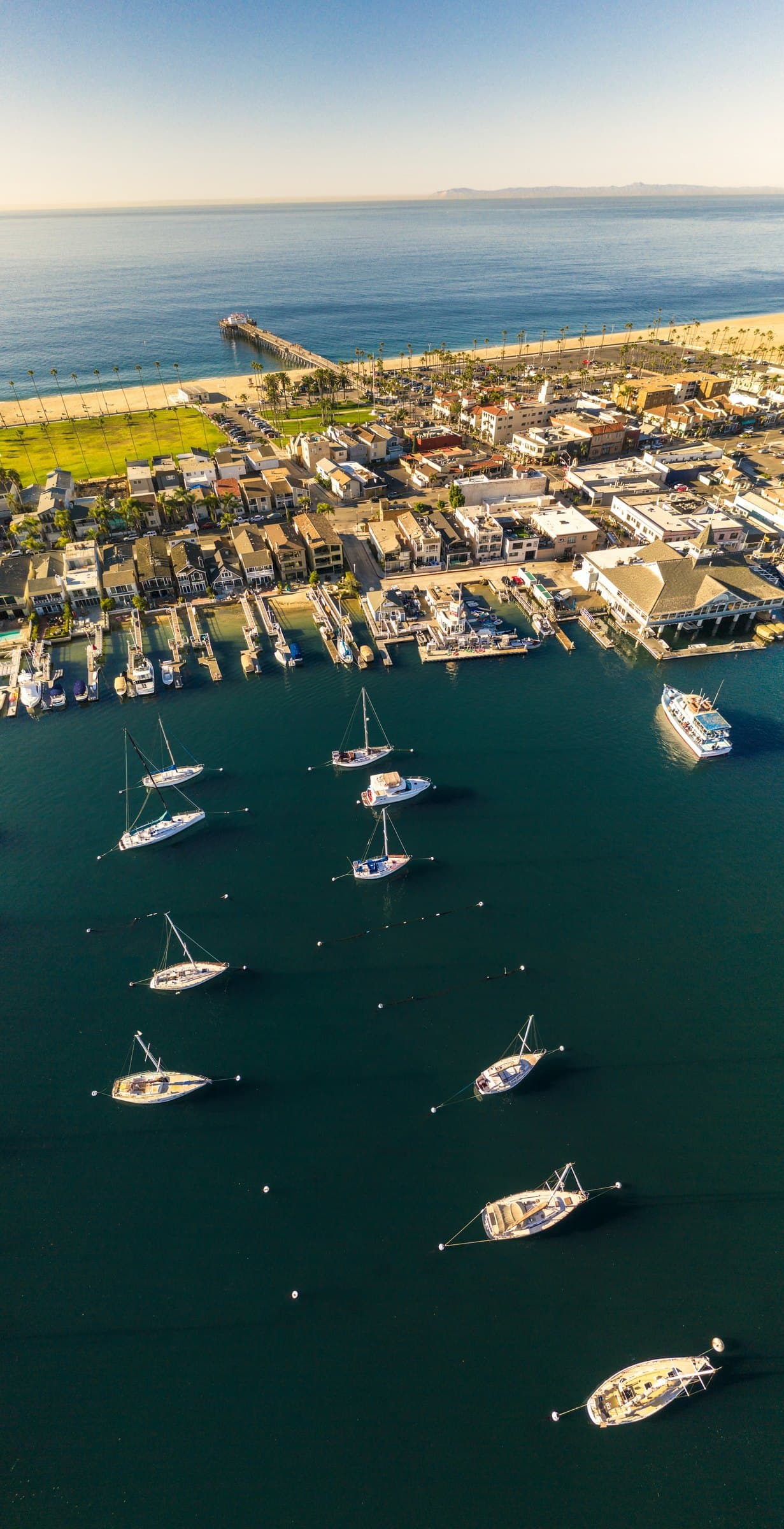 Newport Harbor from above, with the pier and moored boats